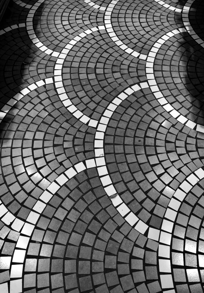 Black and white geometric tile design in Napoli, showcasing artistic patterns and textures.